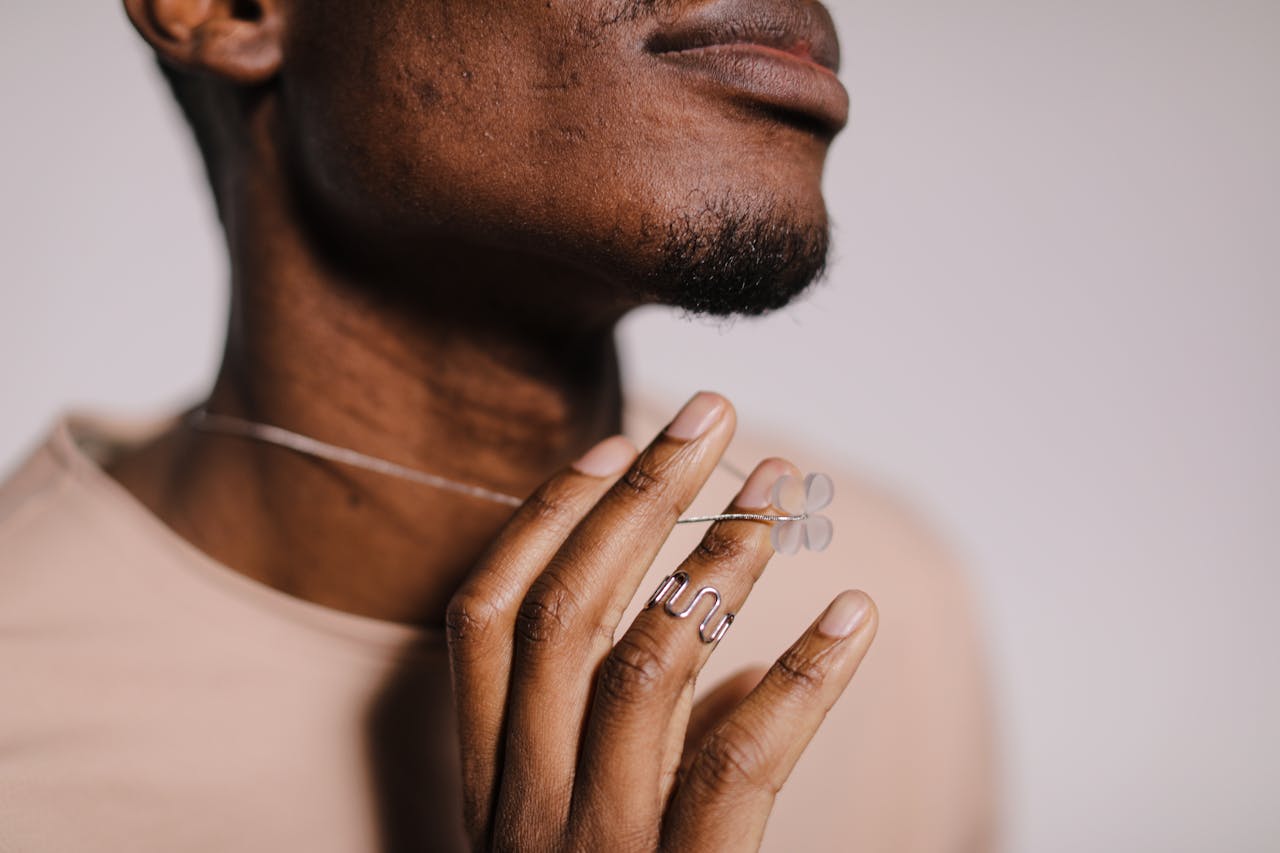 A close-up shot focusing on modern jewelry adorned by a hand, highlighting elegance and style.