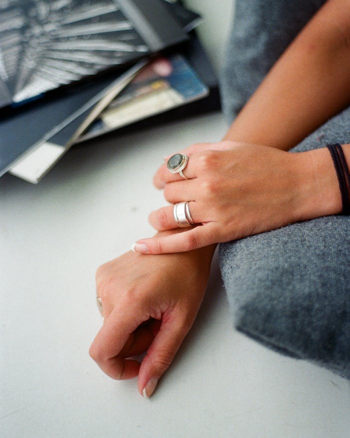 Stylish close-up of hands wearing rings, showcasing elegant accessories and artistic composition.