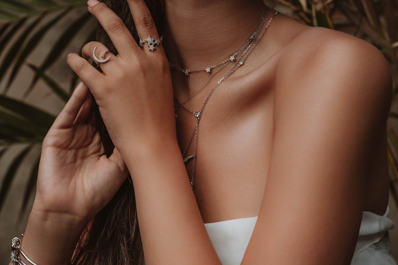 Close-up shot of a woman showcasing elegant jewelry, embodying modern fashion.